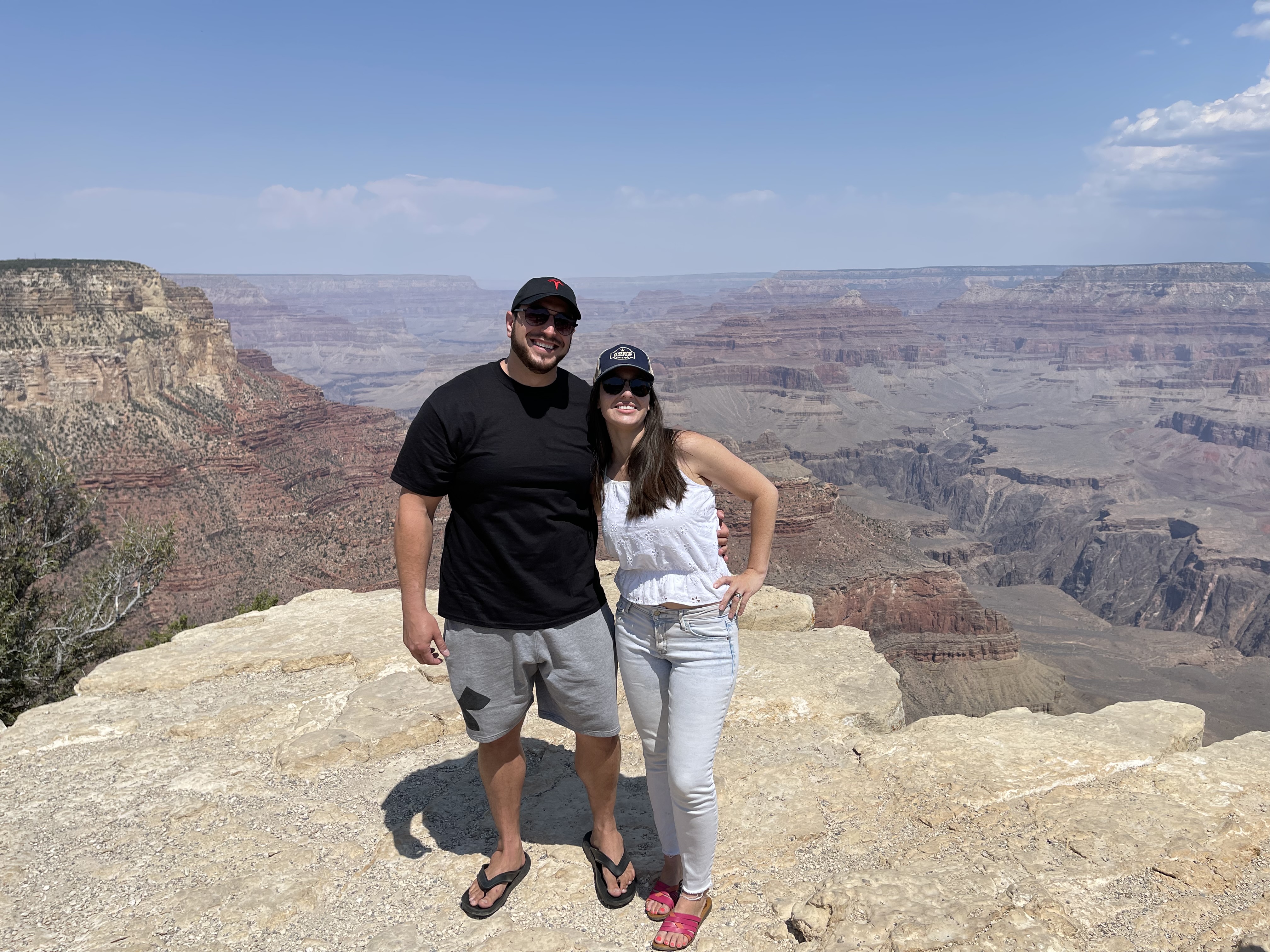 Samantha and a friend at a canyon overlook on a bright day