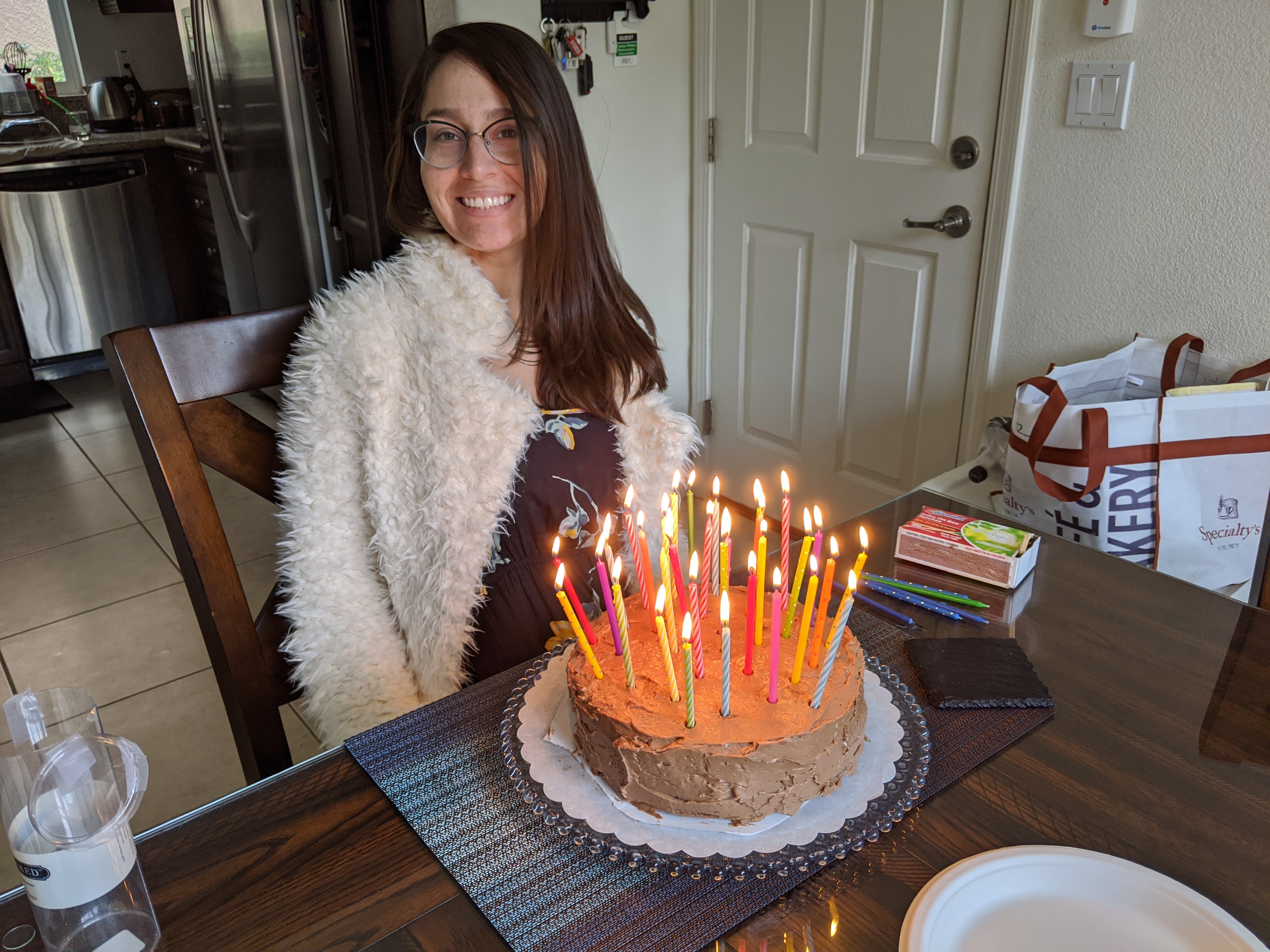 Samantha celebrating with a candle-lit cake at home